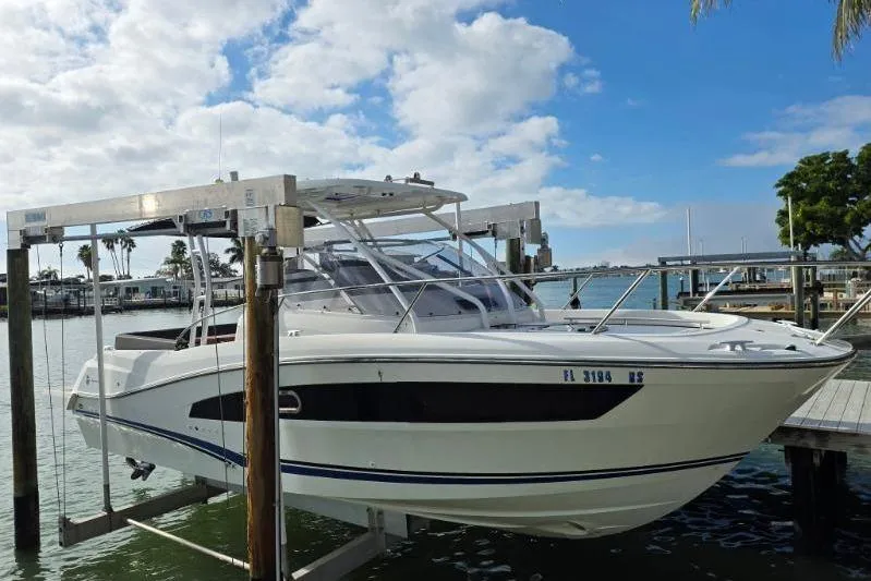 Slide: The Image of 2020 Jeanneau Leader 9.0 WA boat on lift, docked by waterfront. - 1