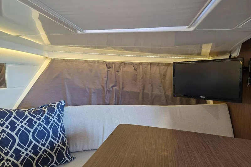 Slide: The Image of Interior of 2020 Jeanneau Leader 9.0 WA boat with TV and cushion. - 8