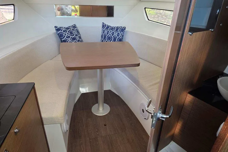 Slide: The Image of 2020 Jeanneau Leader 9.0 WA cabin interior with seating and table, featuring modern design. - 9