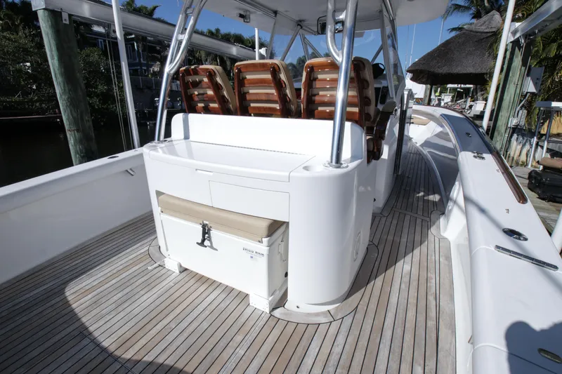 Slide: The Image of 2018 Winter Custom Yachts Center Console boat with teak deck and cushioned seating. - 13