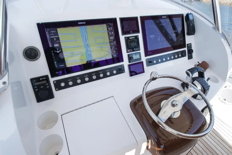Slide: The Image of 2018 Winter Custom Yachts Center Console helm with advanced navigation displays and controls. - 15