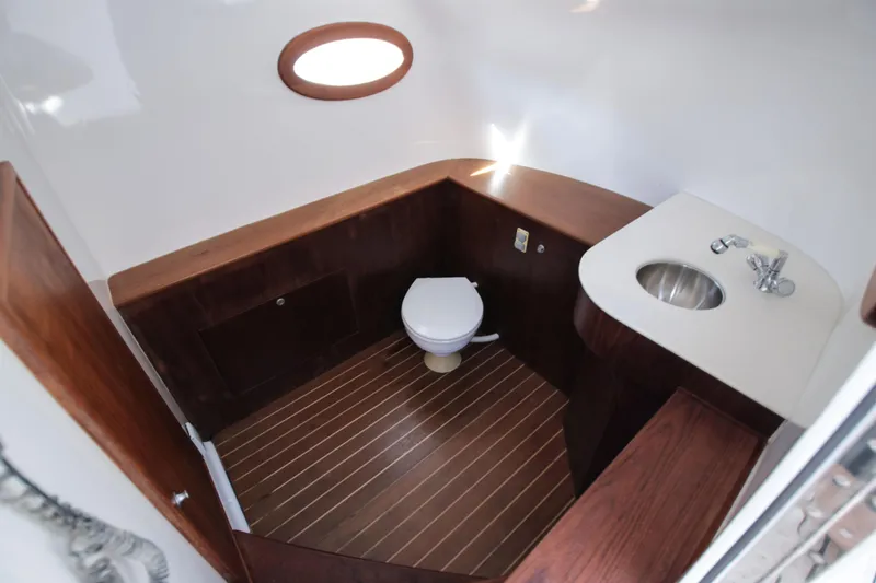 Slide: The Image of 2018 Winter Custom Yachts Center Console bathroom with wooden accents and modern fixtures. - 18