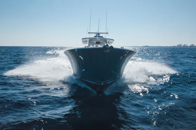 Slide: The Image of 2018 Winter Custom Yachts Center Console cruising on open ocean waters. - 2