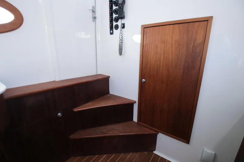 Slide: The Image of Interior of 2018 Winter Custom Yachts Center Console with wooden steps and door. - 20