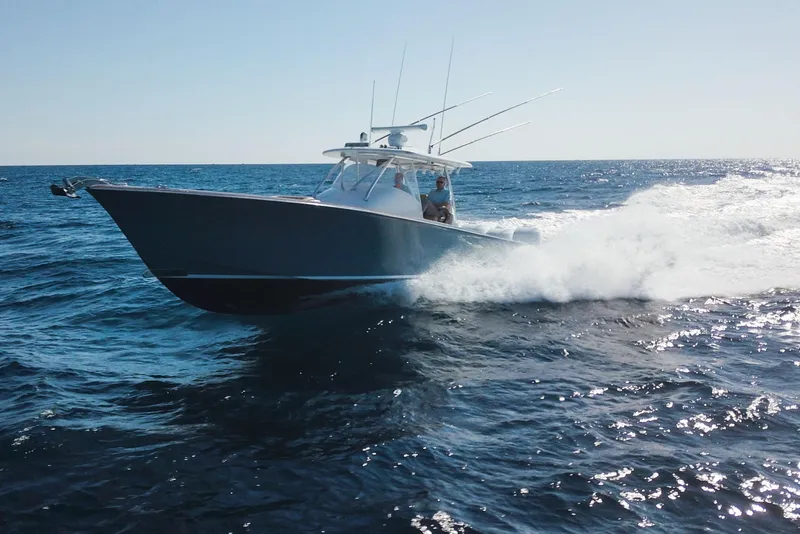 Slide: The Image of 2018 Winter Custom Yachts Center Console cruising on open ocean waters. - 3