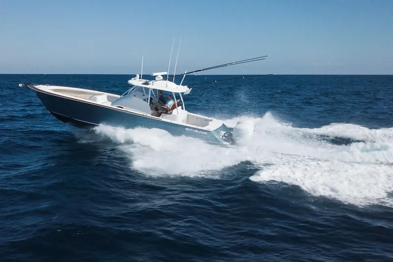 Slide: The Image of 2018 Winter Custom Yachts Center Console cruising on open ocean waters. - 4