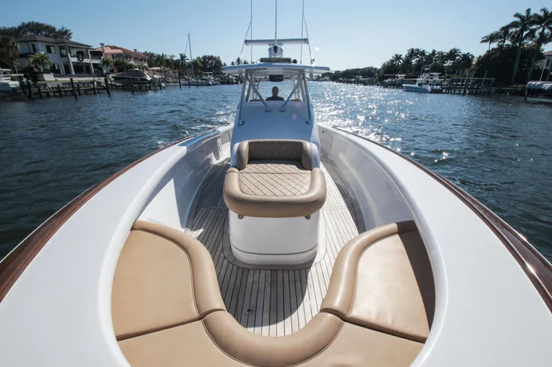 Slide: The Image of 2018 Winter Custom Yachts Center Console boat with luxurious seating on a sunny waterway. - 7