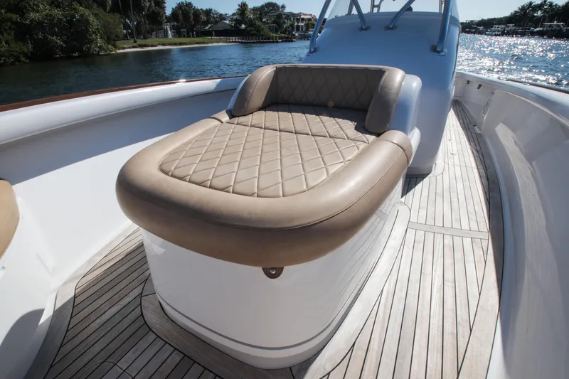 Slide: The Image of 2018 Winter Custom Yachts Center Console with cushioned seating on deck. - 8