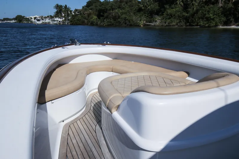 Slide: The Image of 2018 Winter Custom Yachts Center Console boat with cushioned seating on calm water. - 9