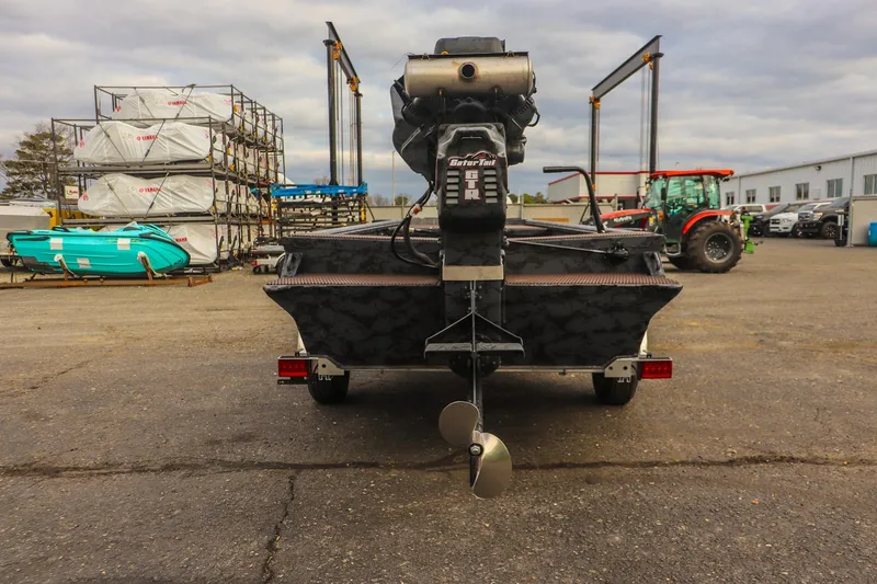 Slide: The Image of 2026 Gator Tail 1860 Extreme series boat with motor, parked in industrial area. - 3