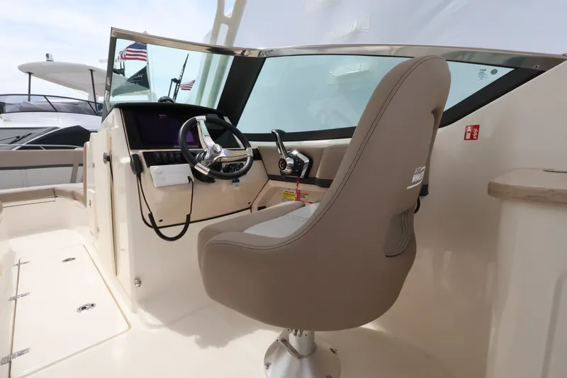 Slide: The Image of The image shows the cockpit of a Boston Whaler 240 Vantage with a comfortable helm seat. - 14
