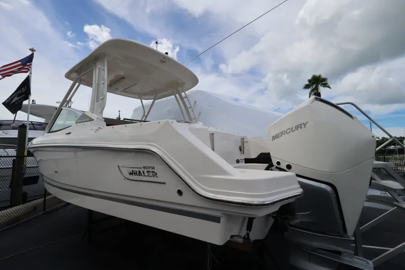 Slide: The Image of A 2026 Boston Whaler 240 Vantage on a trailer. A Mercury engine is visible. - 2