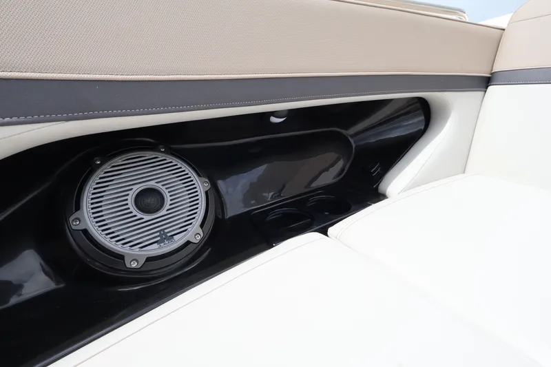 Slide: The Image of Close-up of a speaker in a Boston Whaler 240 Vantage boat, surrounded by beige upholstery. - 26