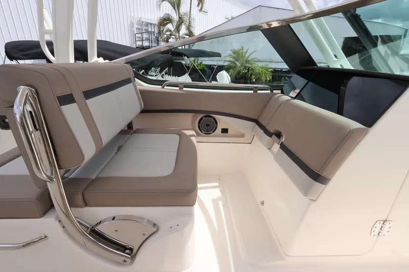Slide: The Image of Interior of a 2026 Boston Whaler 240 Vantage with beige seating and stainless steel accents. - 20