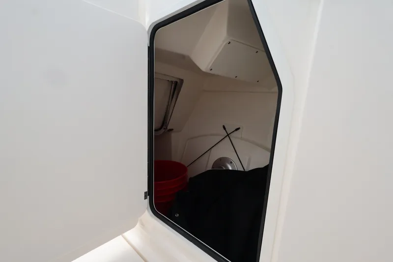 Slide: The Image of A storage compartment with a red bucket and black items. - 23
