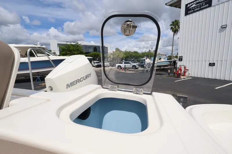 Slide: The Image of A 2026 Boston Whaler 240 Vantage with a Mercury engine, parked at a marina. - 9