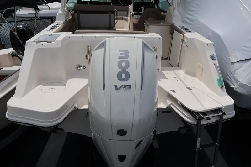 Slide: The Image of The image shows the stern of a Boston Whaler 240 Vantage with a 300 HP V8 engine. - 4
