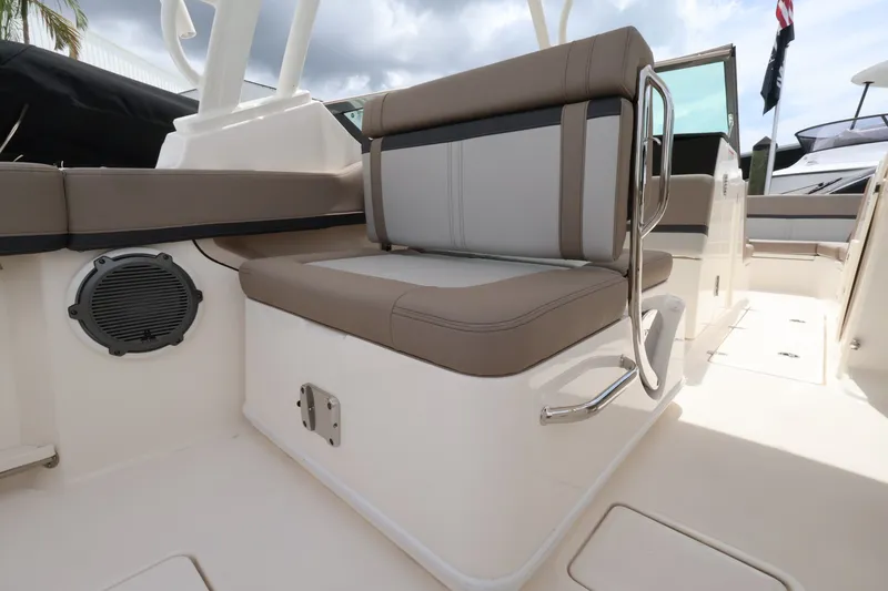 Slide: The Image of The 2026 Boston Whaler 240 Vantage features a comfortable bench seat with gray and beige upholstery. - 10