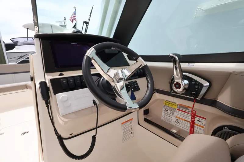 Slide: The Image of The image shows the helm of a Boston Whaler 240 Vantage with modern controls. - 16