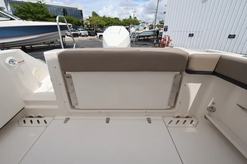 Slide: The Image of The image shows the stern of a Boston Whaler 240 Vantage boat with seating and storage. - 6