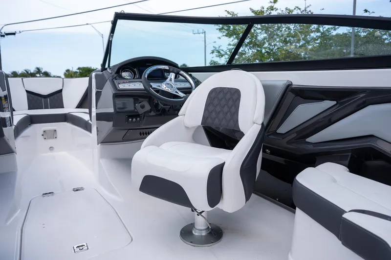 Slide: The Image of 2024 Monterey 235SS Super Sport boat interior with modern steering and seating. - 9