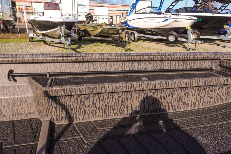 Slide: The Image of 2026 Gator Tail 1860 Extreme series boat with camouflage design, parked outdoors. - 11
