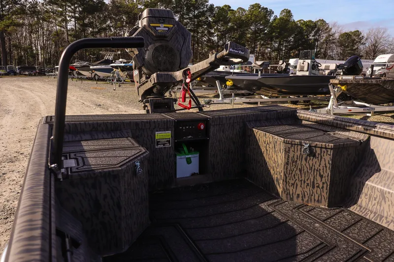 Slide: The Image of 2026 Gator Tail 1860 Extreme series boat in a lot, surrounded by trees. - 9