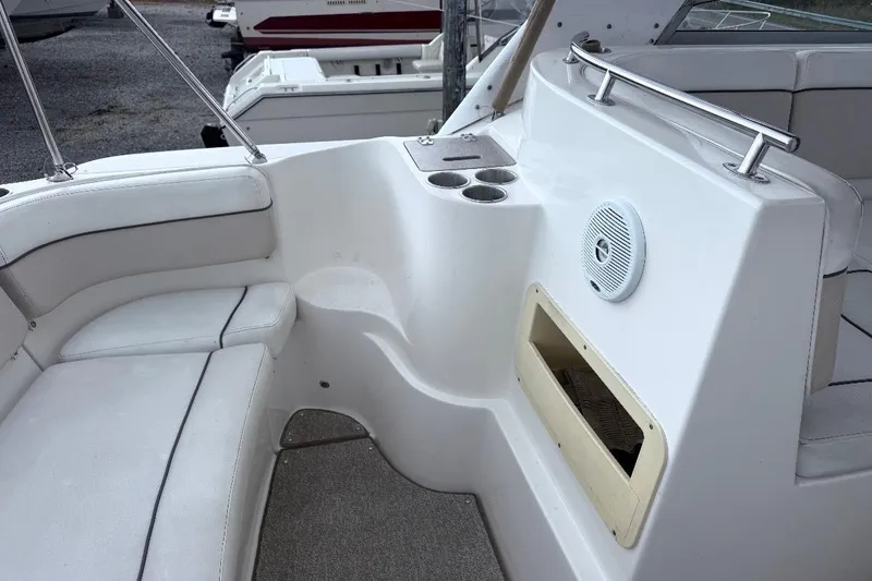 Slide: The Image of 2006 Rinker Fiesta Vee 300 boat interior with seating, cup holders, and speaker. - 6