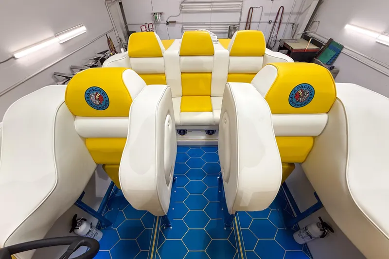 Slide: The Image of Interior of a 1998 Apache 36 WARRIOR boat with yellow and white seating. - 14