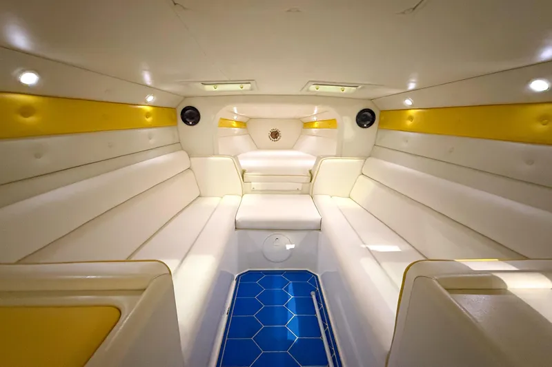 Slide: The Image of Luxurious interior of a 1998 Apache 36 WARRIOR boat with white and yellow seating. - 20