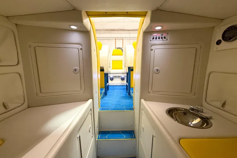 Slide: The Image of Interior of a 1998 Apache 36 WARRIOR boat, featuring a compact cabin with sink and storage. - 24