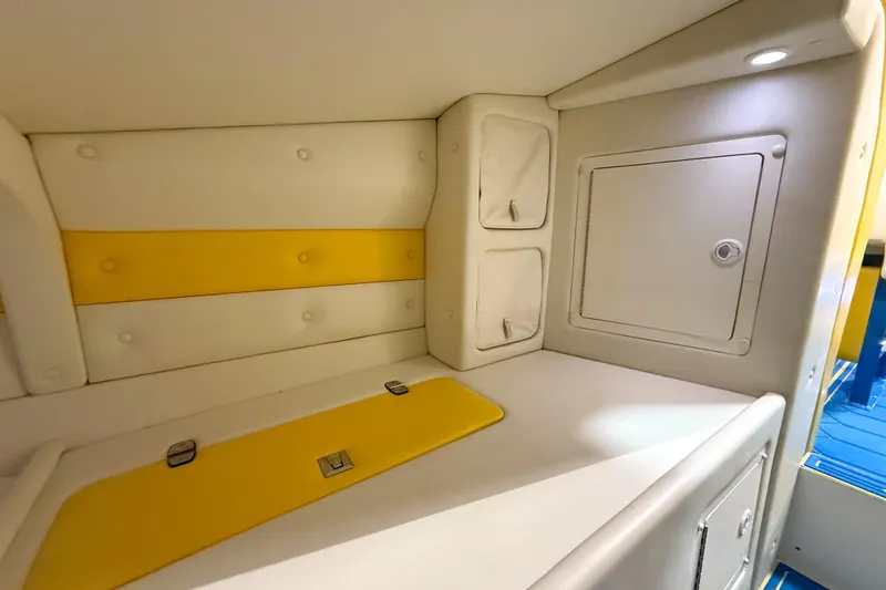 Slide: The Image of Interior cabin of 1998 Apache 36 WARRIOR boat with yellow and white upholstery. - 26