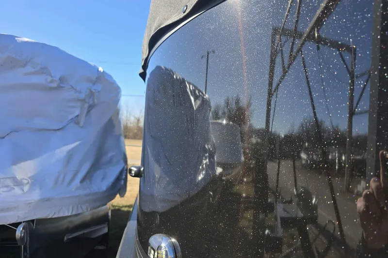 Slide: The Image of 2026 Dockside 22DQ17.5 boat with reflective surface and covered structure in sunlight. - 4