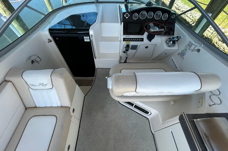 Slide: The Image of 2012 Sea Ray Sundancer 310 boat deck with cushioned seating at dock. - 113