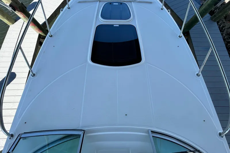 Slide: The Image of 2012 Sea Ray Sundancer 310 cabin entrance with open hatch, dockside view. - 120