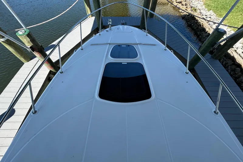 Slide: The Image of Interior of 2012 Sea Ray Sundancer 310 with beige seating and wooden table. - 121