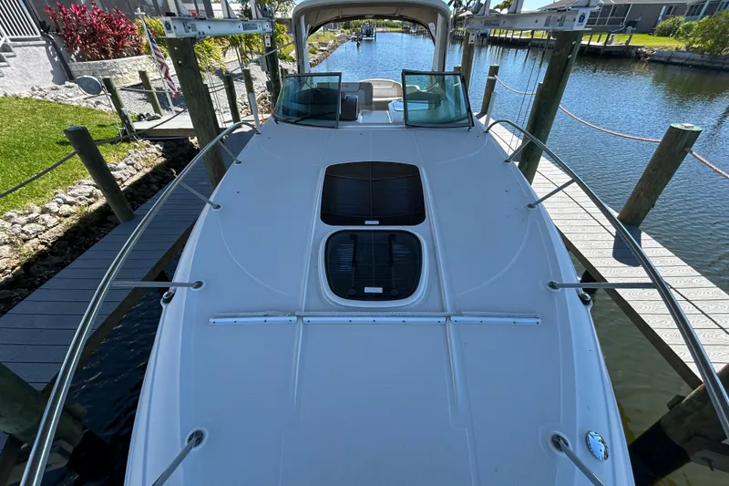 Slide: The Image of Interior of 2012 Sea Ray Sundancer 310 with wooden cabinetry and small window. - 126