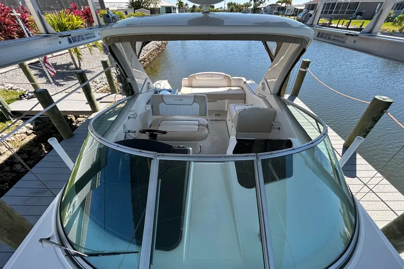 Slide: The Image of Interior cabinet of 2012 Sea Ray Sundancer 310 boat, featuring wooden finish and metal hinges. - 132