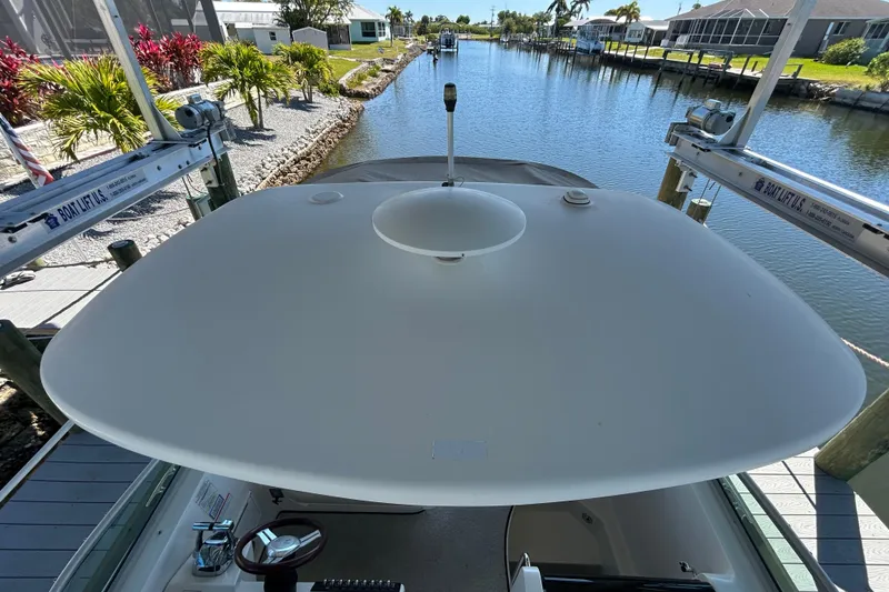 Slide: The Image of Interior cabin of 2012 Sea Ray Sundancer 310 with wooden cabinetry and porthole window. - 133