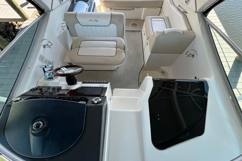 Slide: The Image of Interior cabinet of 2012 Sea Ray Sundancer 310 boat, featuring wooden finish and open storage. - 134