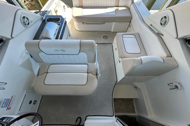 Slide: The Image of Interior storage compartment in 2012 Sea Ray Sundancer 310 boat with beige seating. - 136