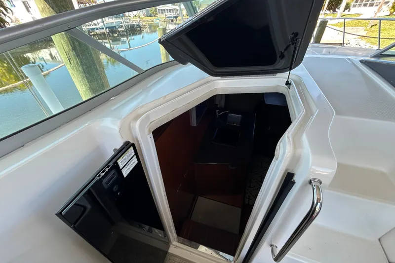 Slide: The Image of Empty wooden cabinet interior on a 2012 Sea Ray Sundancer 310 boat. - 143