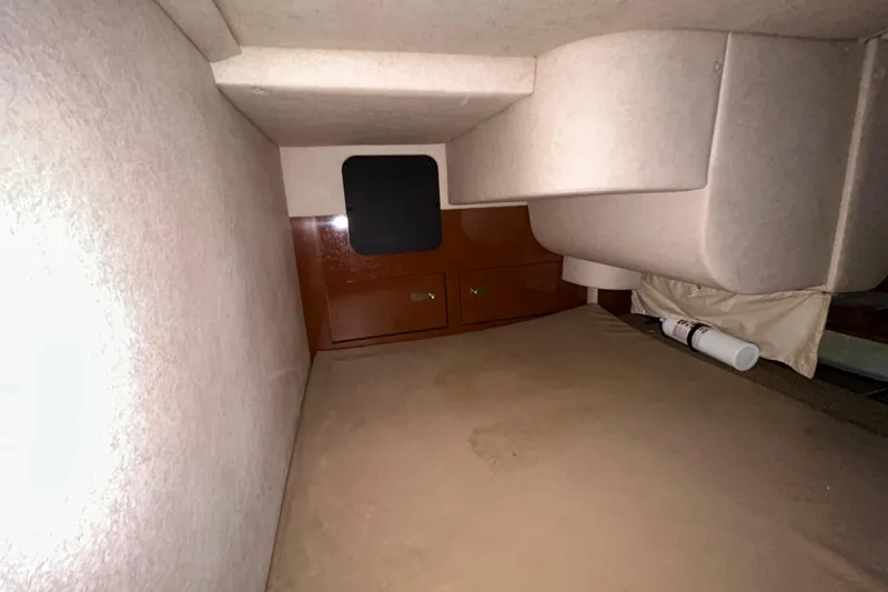 Slide: The Image of Battery compartment of a 2012 Sea Ray Sundancer 310 boat, featuring wooden flooring. - 147
