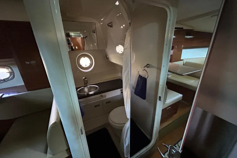 Slide: The Image of Wooden cabinet door inside a 2012 Sea Ray Sundancer 310 boat interior. - 159
