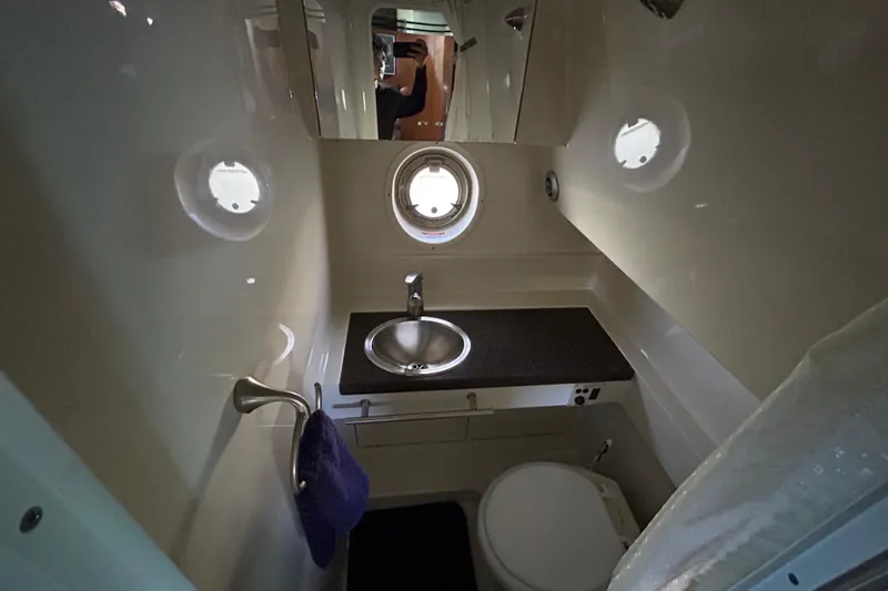 Slide: The Image of 2012 Sea Ray Sundancer 310 interior with TV, remote, and audio system. - 160