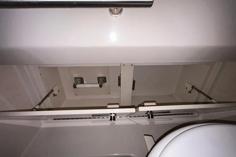 Slide: The Image of 2012 Sea Ray Sundancer 310 galley with microwave, sink, and dark countertop. - 162