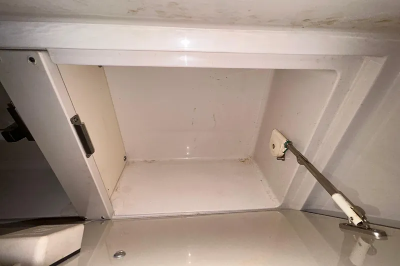 Slide: The Image of Open wooden cabinet inside a 2012 Sea Ray Sundancer 310 boat. - 164