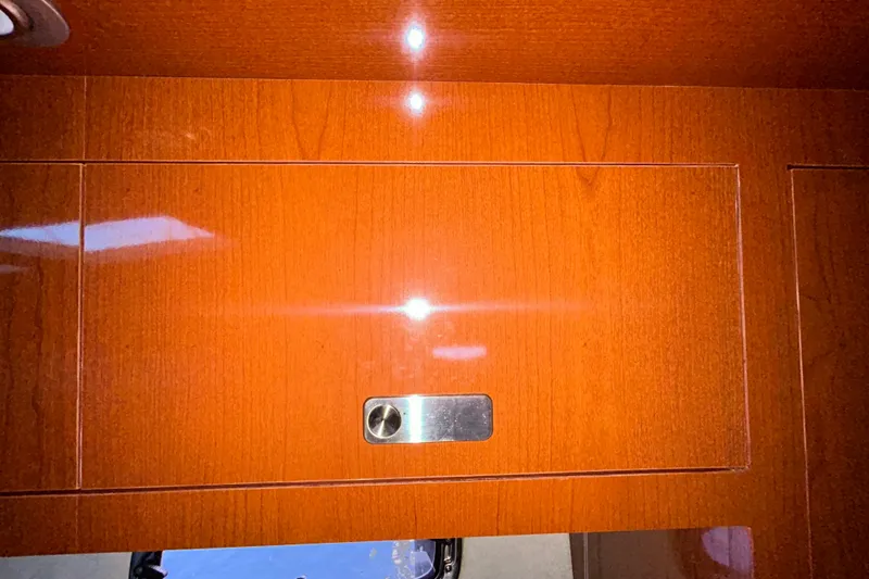 Slide: The Image of Under-sink cabinet in 2012 Sea Ray Sundancer 310 with fire extinguisher and trash bin. - 171