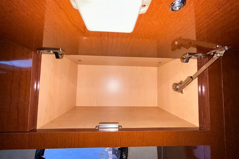 Slide: The Image of Open refrigerator inside a 2012 Sea Ray Sundancer 310 yacht, showing interior storage space. - 172