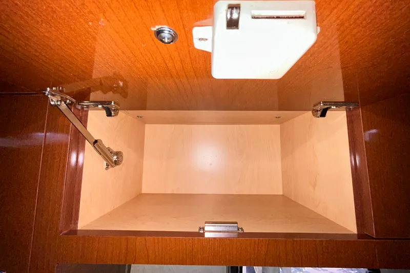 Slide: The Image of Open wooden cabinet inside 2012 Sea Ray Sundancer 310 boat. - 174